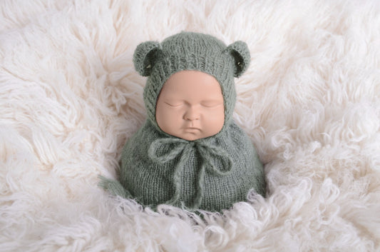 Newborn photography prop featuring a beige mohair bear bonnet and sack on a plush white background, designed for a serene and soft aesthetic.