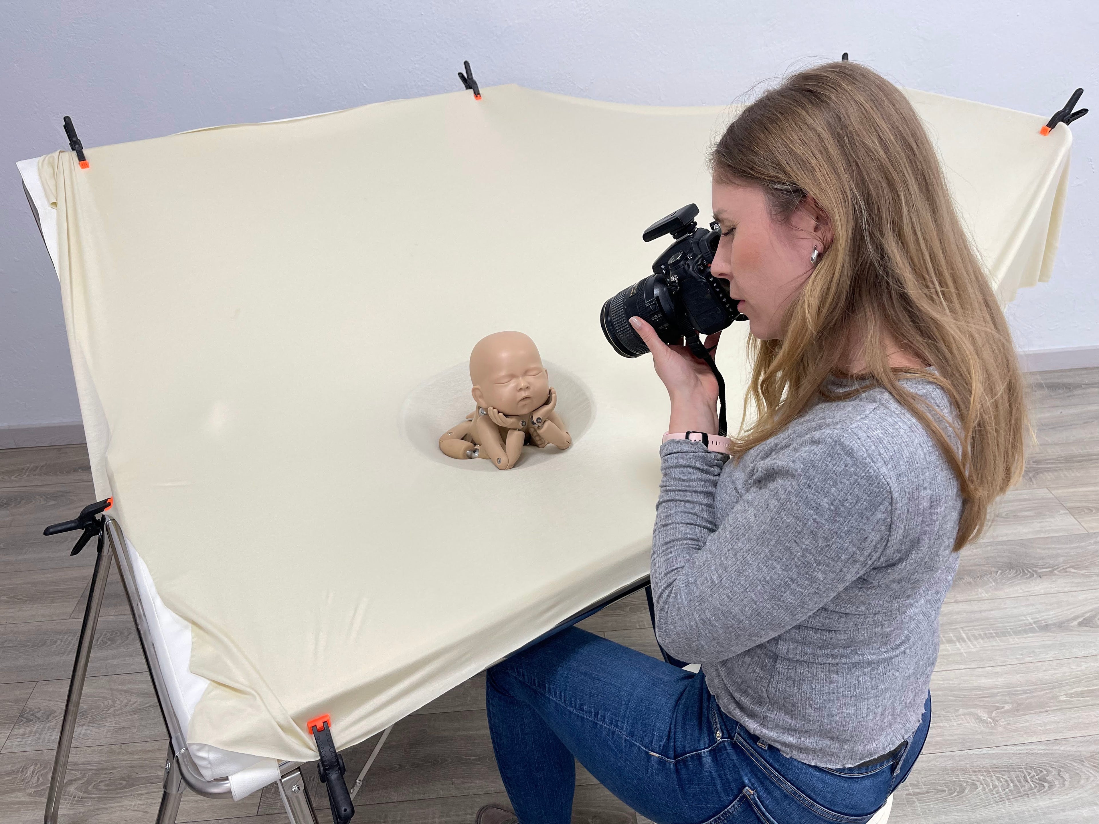 Newborn Photographer practicing using Posing Table