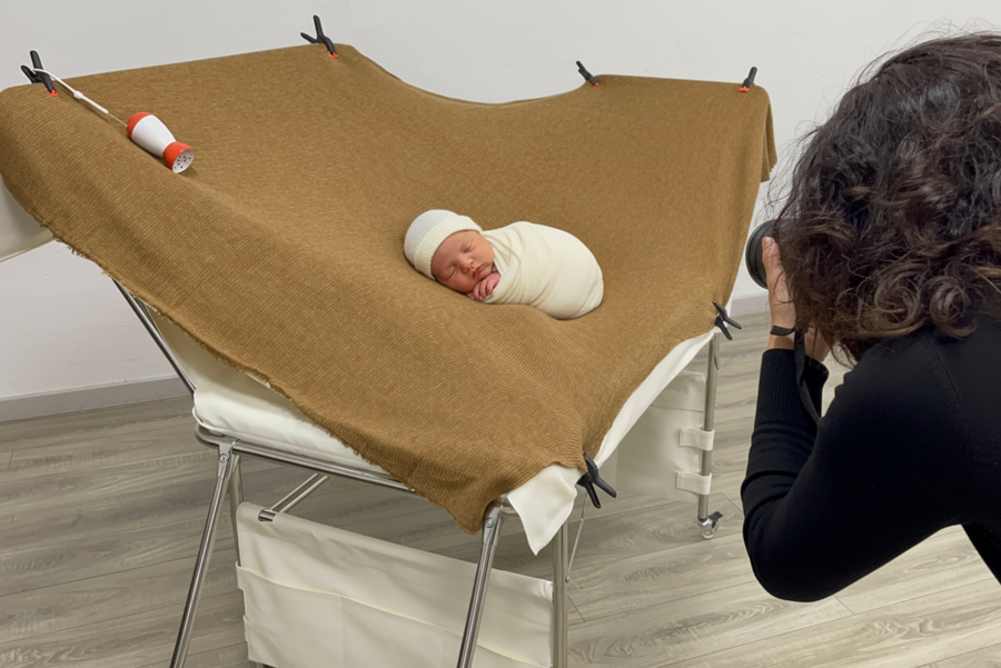 Photographer using the posing table with a newborn