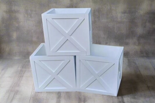 Stacked white wooden crates with X-panel details, perfect as a newborn photography prop or cake smash setup.