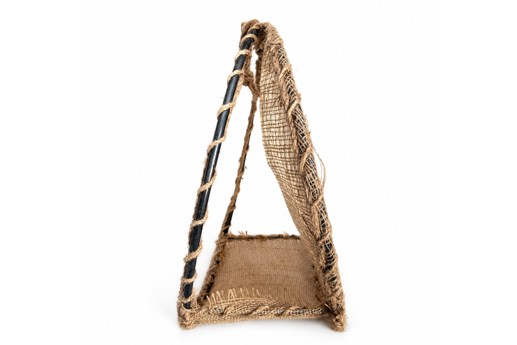 Side-view of a circular woven basket Round Rustic Swing made from natural jute rope, burlap fabric, and metal frame. Newborn photography prop.