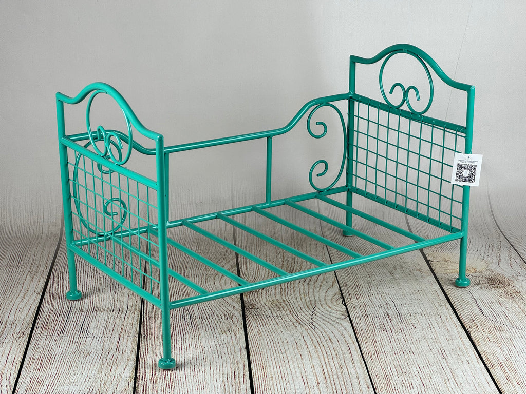 Delicately crafted metallic green bed with vintage wire accents, ideal for baby photoshoots.