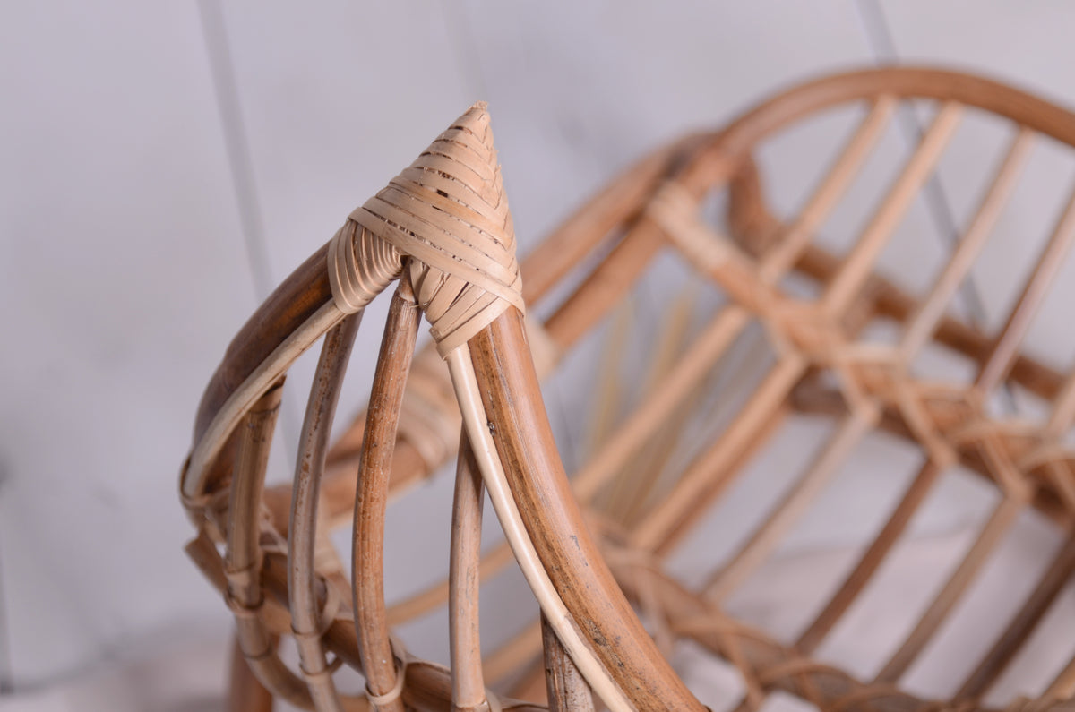 Detailed close-up of the crescent moon rattan chair, showcasing the intricate weaving and natural texture of the rattan material.