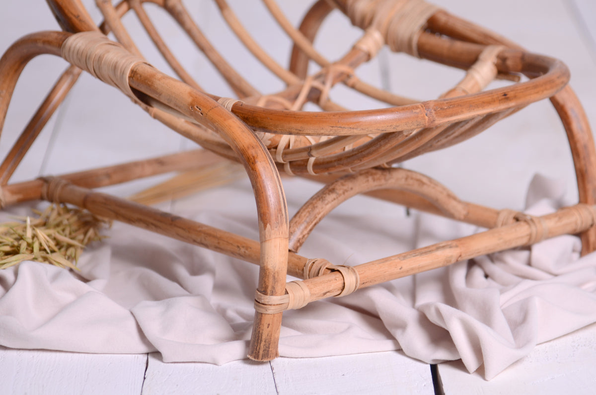 Macro shot of the rattan bindings and intersections, highlighting the craftsmanship and organic curves of the crescent moon design.