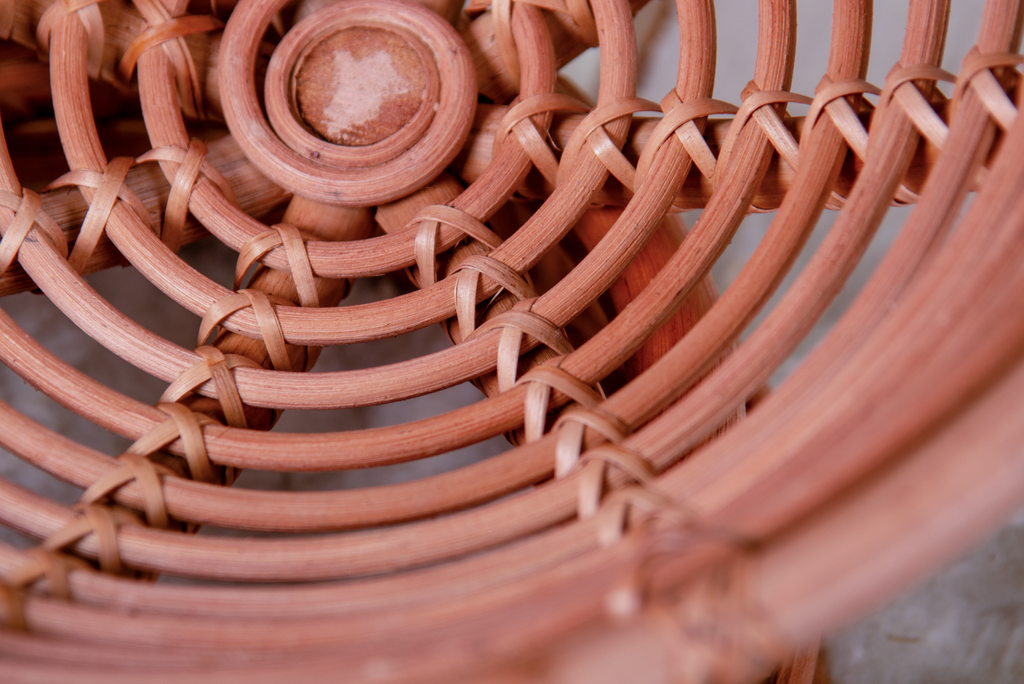 Detail shot showing the woven rattan pattern inside the newborn photography prop papasan bed.