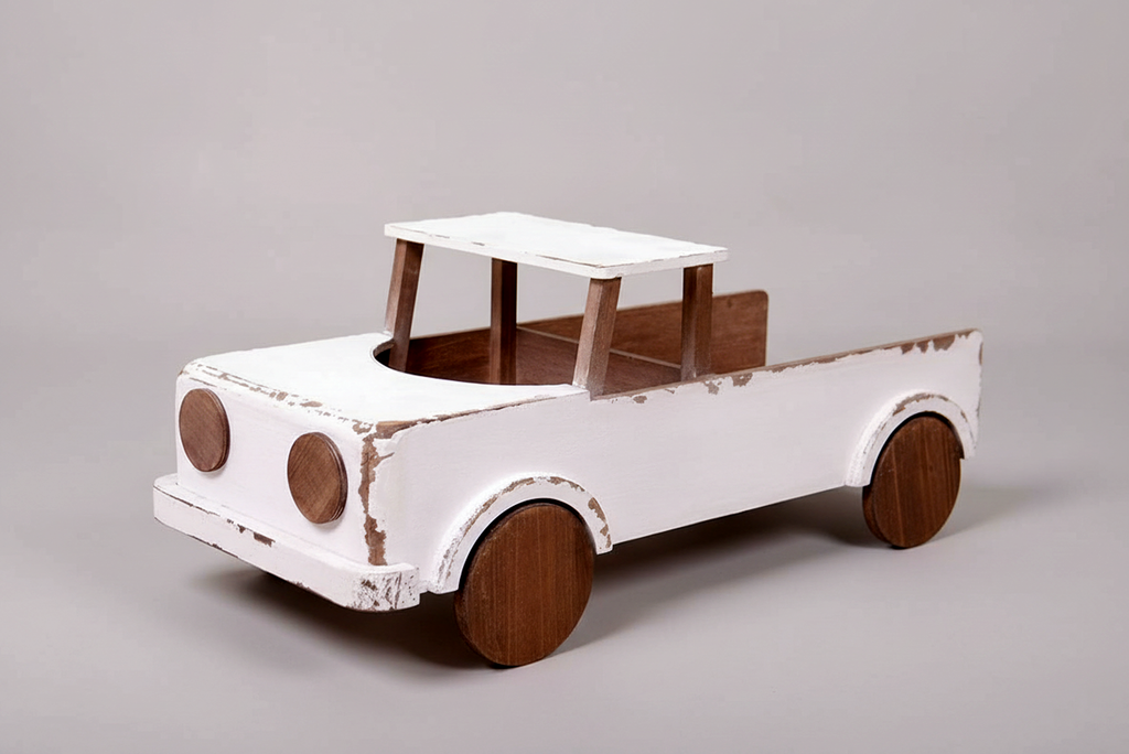 Rustic wooden pickup truck with distressed white paint, used as a baby photography prop for milestone sessions