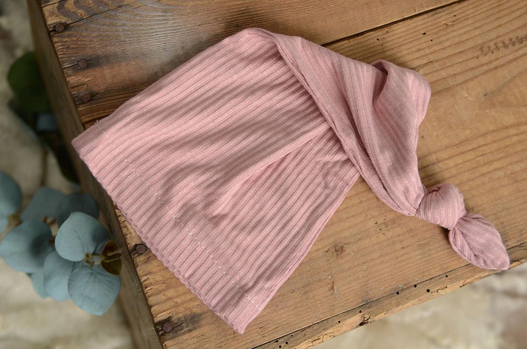 Pink knitted hat flatlay shot