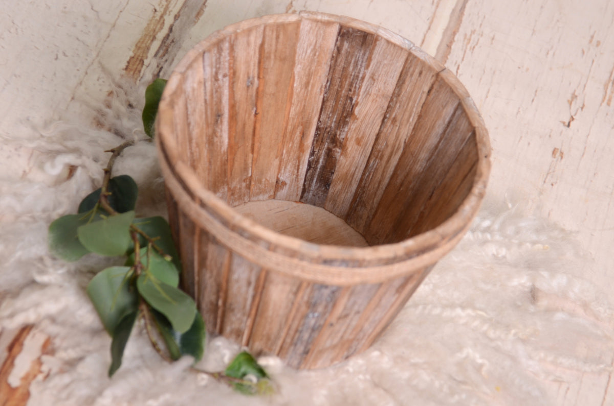 Driftwood-style wooden bucket with a rope accent around the rim, a charming newborn photography prop.