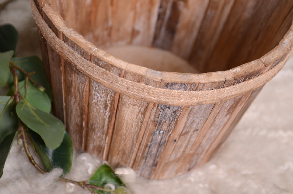 Natural wooden bucket featuring a rope-rim detail, ideal for rustic newborn photography setups.