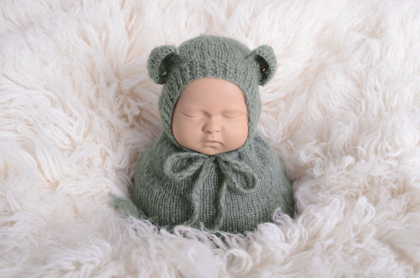 Newborn photography prop featuring a beige mohair bear bonnet and sack on a plush white background, designed for a serene and soft aesthetic.