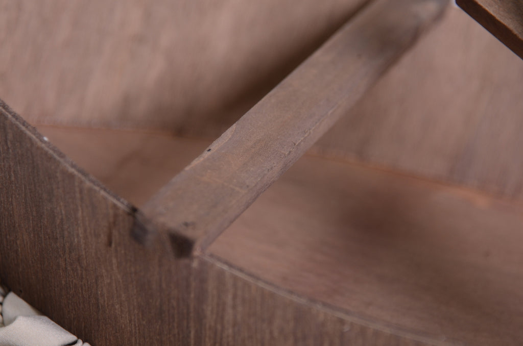 Center support beam inside wooden canoe newborn photography prop, showing structural detail and depth.