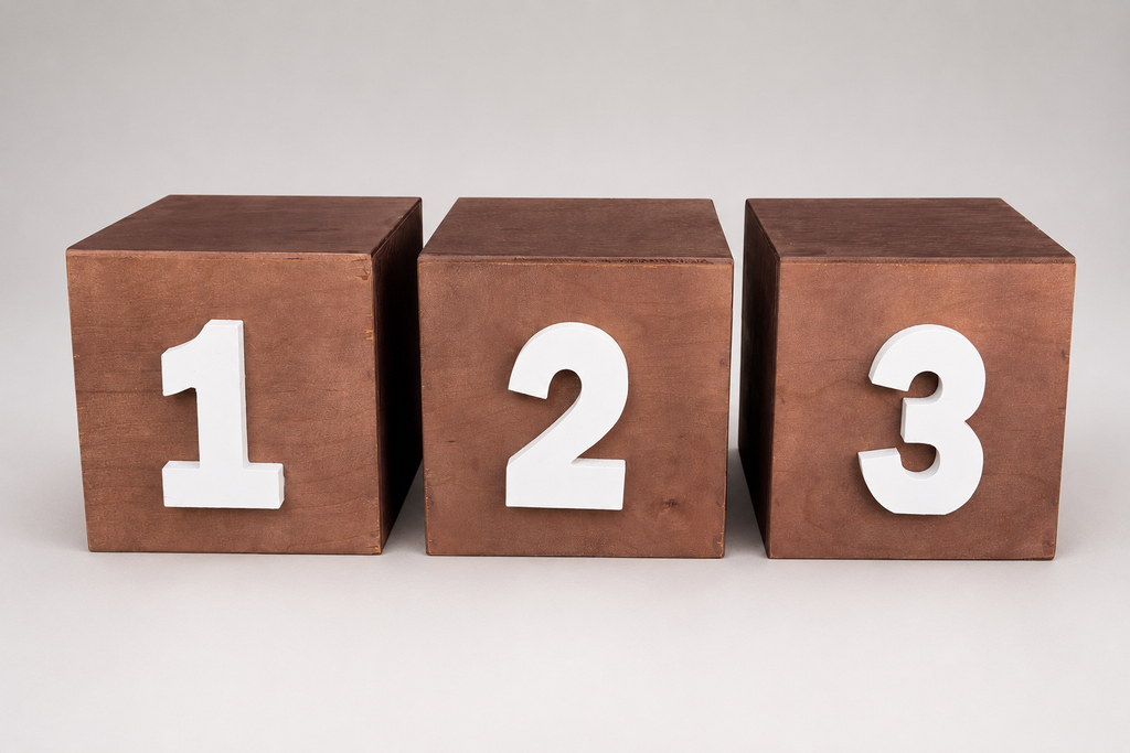 Three wooden cube blocks with the numbers 1, 2, and 3 in white, ideal for cake smash photography