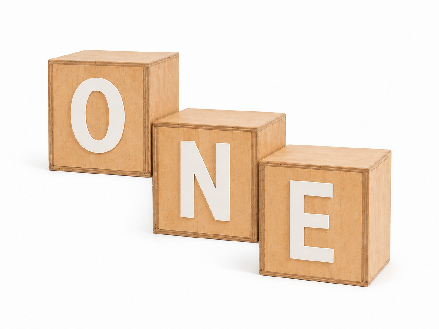 Three wooden cubes with the letters O, N, and E in white, arranged to spell ONE. Decoration for cake smash photography and milestone sessions.