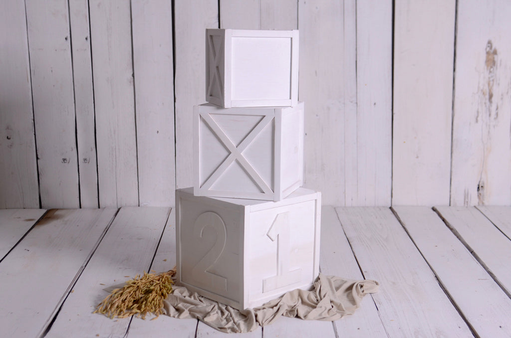 Three-tier white crate stack with carved numbers, ideal newborn photography prop for cakesmash sessions.