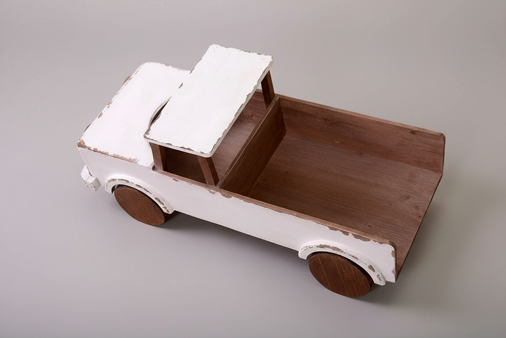 Top view of a rustic wooden pickup truck with a distressed white finish, used as a baby photography prop for milestone sessions. Large pickup bed for posing.