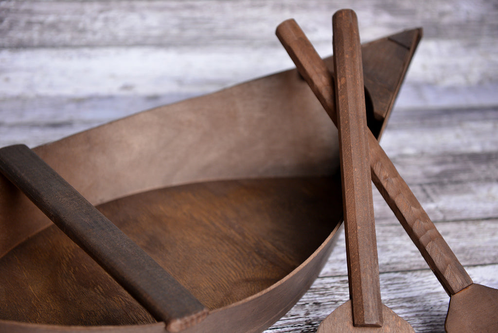 Close-up of a wooden boat newborn photography prop with two oars