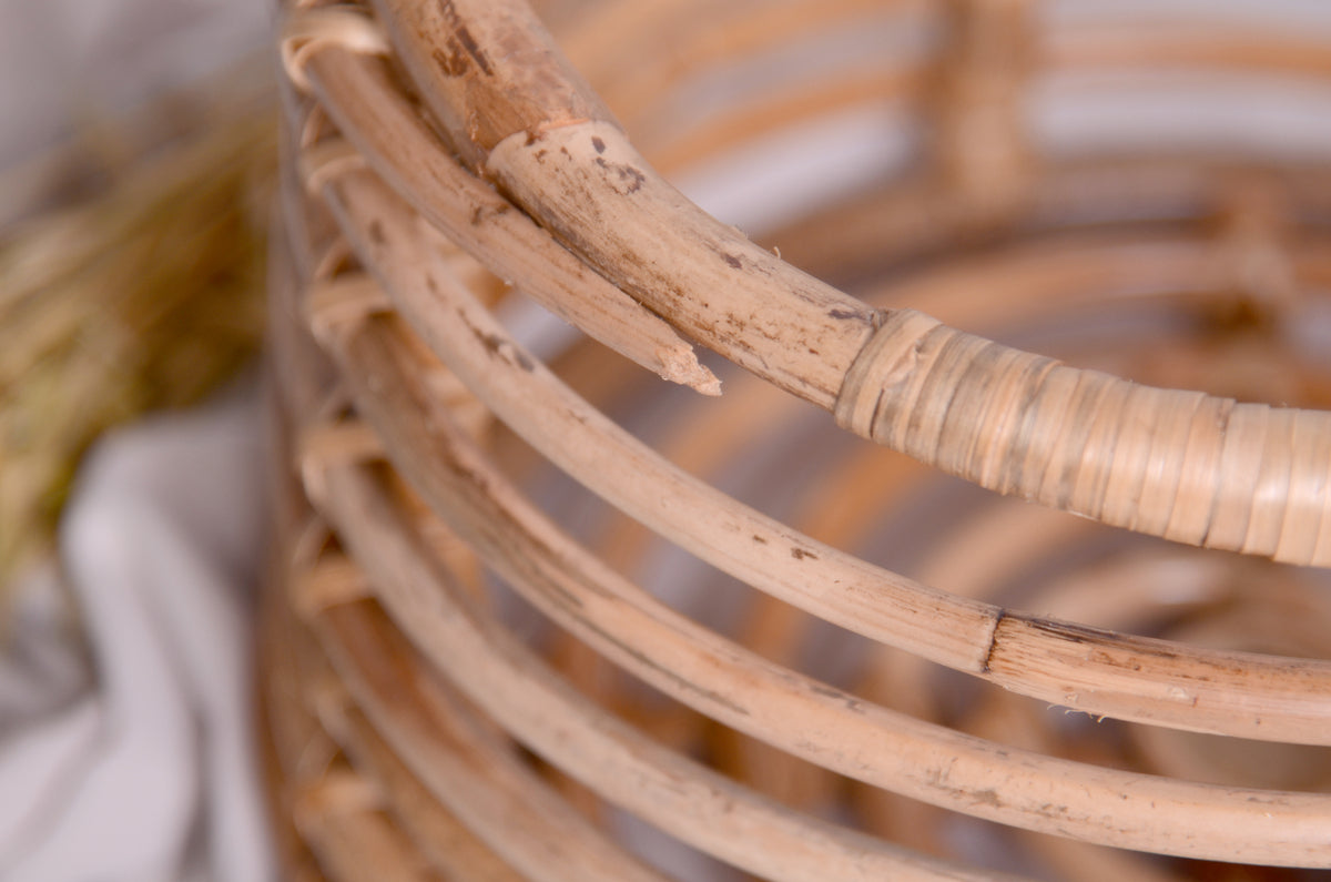 Earthy and timeless newborn photography prop, a handcrafted rattan bowl, side detail shot.