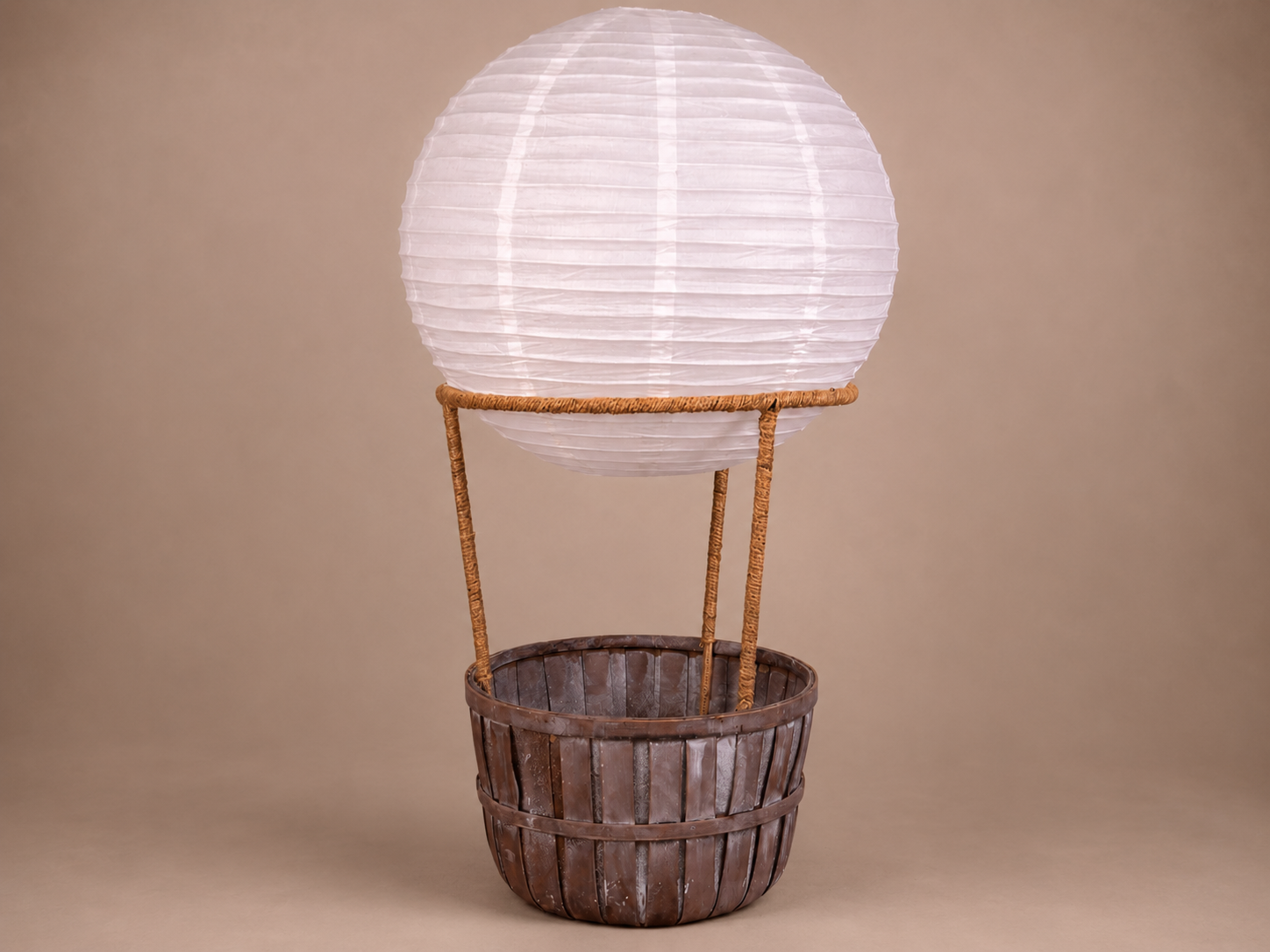 Decorative lantern shaped like a hot air balloon with wooden basket