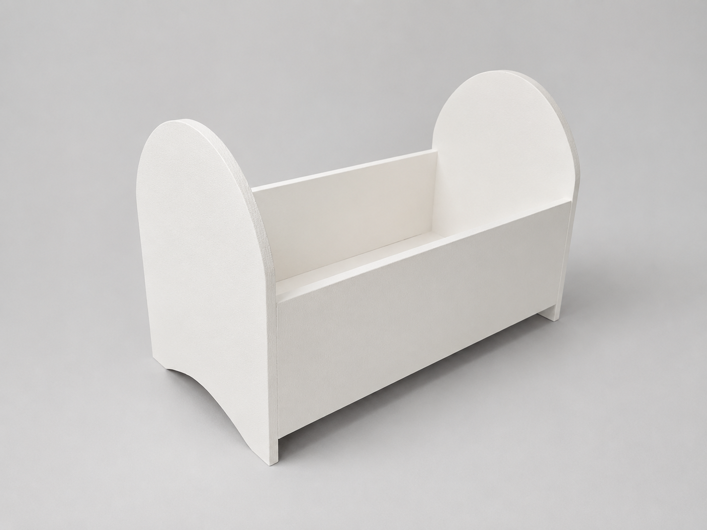 White doll crib on a gray background