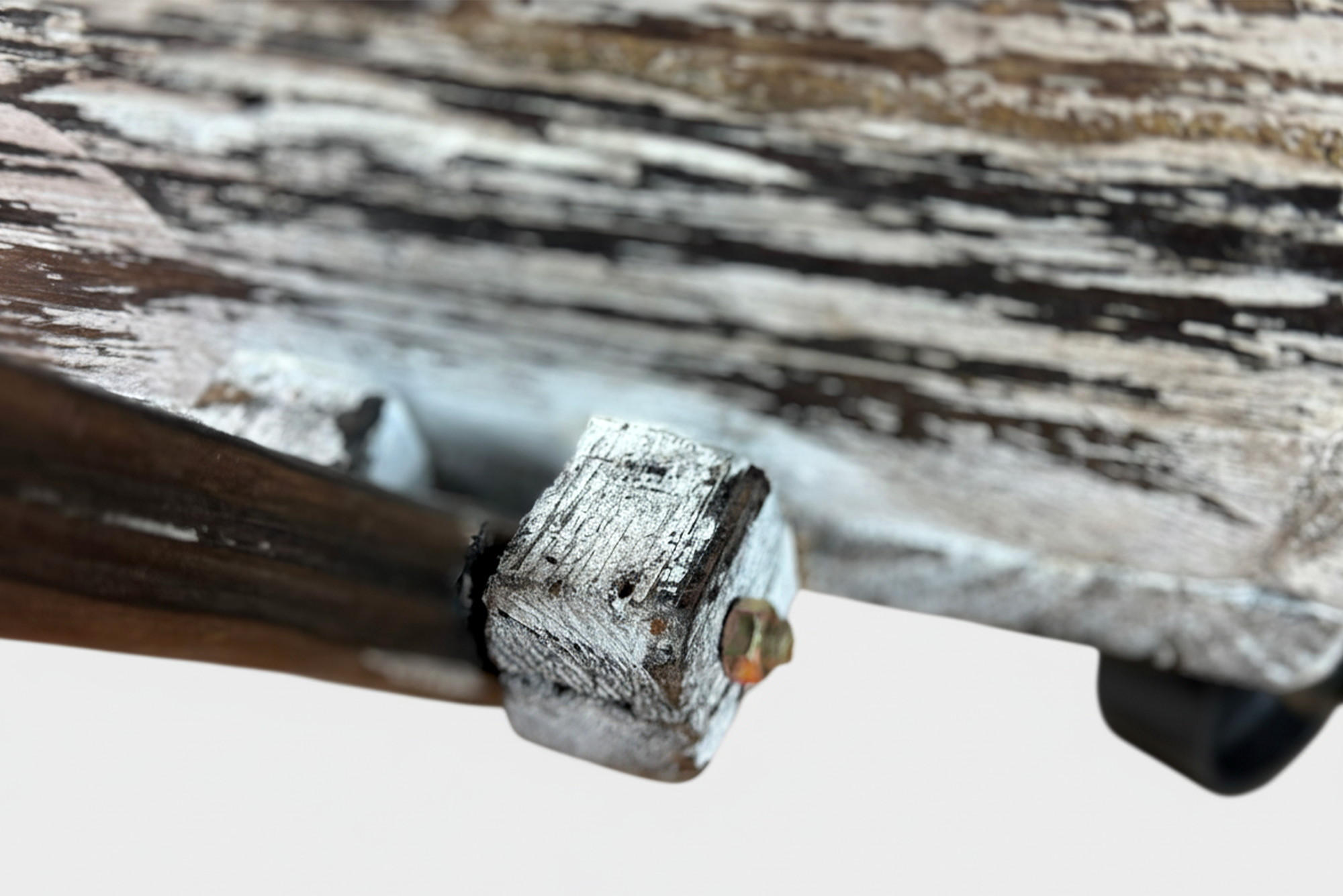 Close-up of the wagon’s worn wood and metal bolt detail, highlighting craftsmanship in this newborn photography prop.