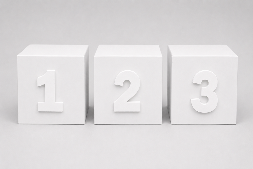Three white cube blocks for cake smash photography arranged side by side, each displaying a raised number from 1 to 3