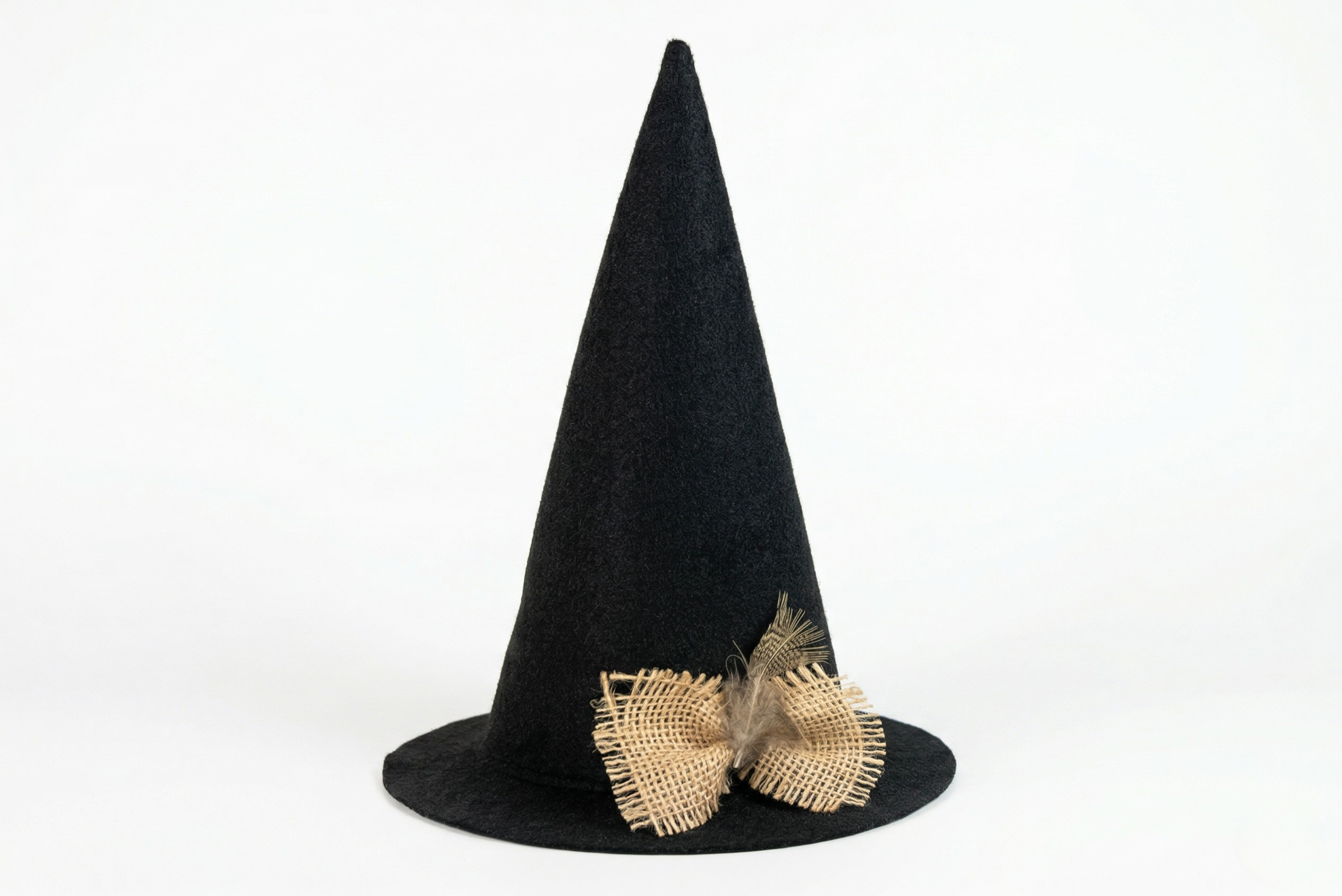 Black witch hat with burlap bow on a white background