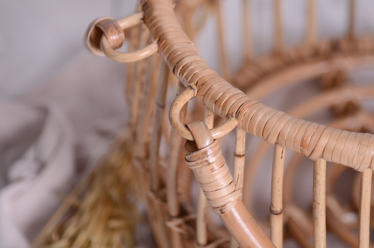 A close-up look at the fine craftsmanship of this rattan basket, highlighting its delicate yet sturdy weaving, perfect for newborn photography setups.