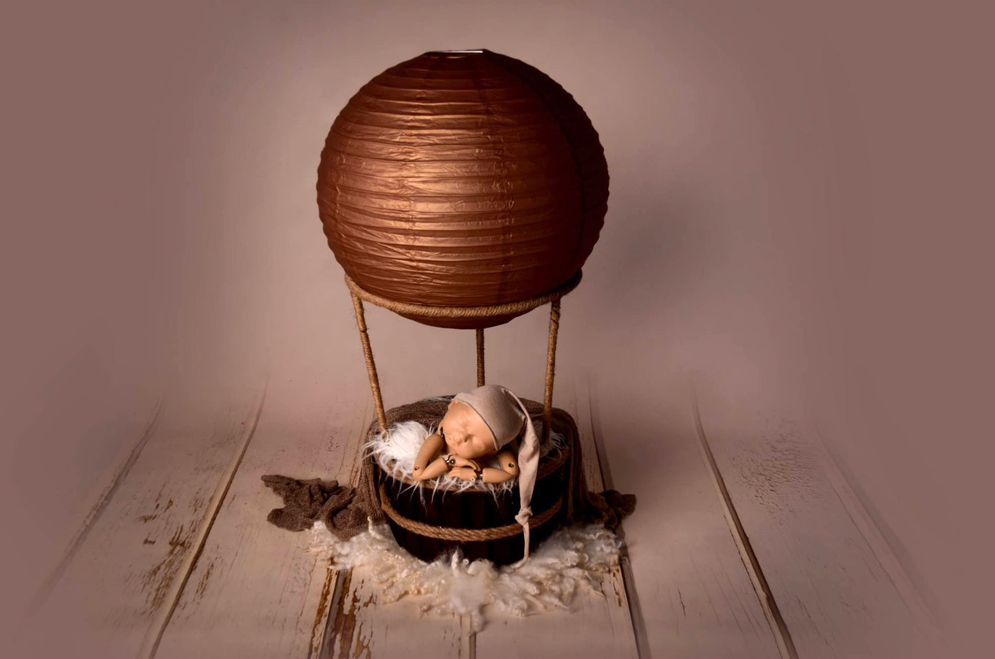 Hot air balloon-inspired newborn photography prop including balloon top in 6 different colors, natural jute ropes, and a deep burgundy wooden basket. Perfect for unique and enchanting newborn photos.