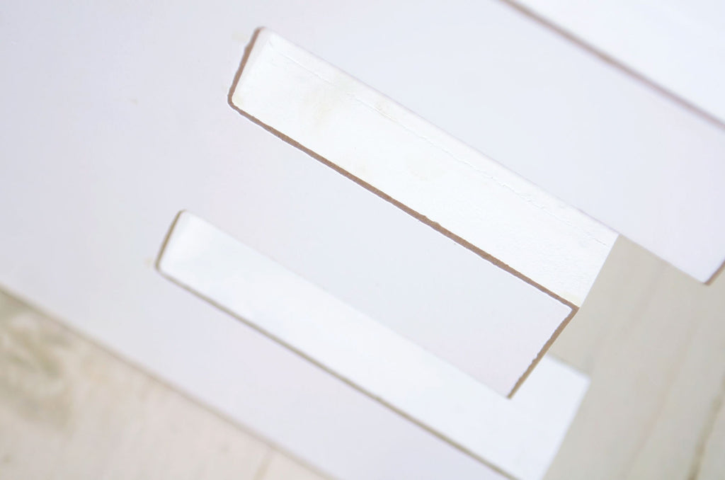 White wooden letters spelling out 'ONE' on a rustic wooden background, ideal for cake smashes or milestone photography.