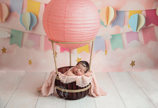 Hot air balloon-inspired newborn photography prop including balloon top in 6 different colors, natural jute ropes, and a deep burgundy wooden basket. Perfect for unique and enchanting newborn photos.